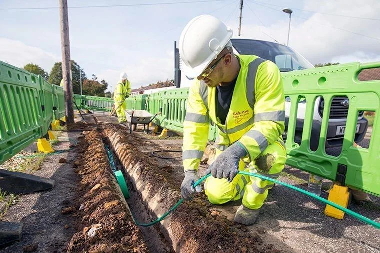Telecom engineer installing fibre optic cable as part of UK telecom infrastructure services and data cabling project